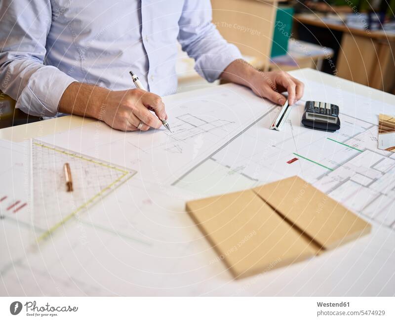 Architect working on construction drawing architect architects floor plan floor plans ground plan ground plans construction drawings Planning planning planned
