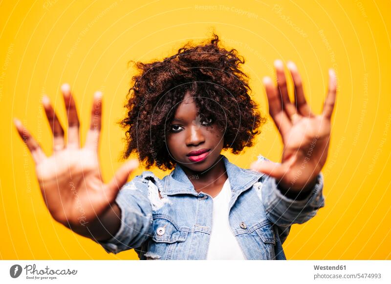 Portrait of beautiful young woman in studio raising her arms human human being human beings humans person persons African black black ethnicity coloured