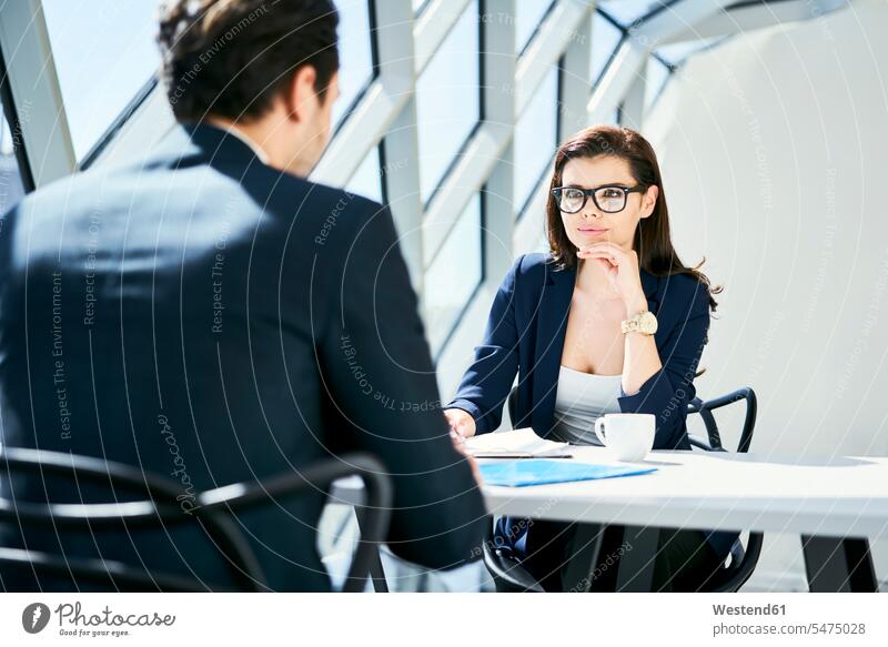 Businesswoman looking at businessman in modern office talking speaking offices office room office rooms businesswoman businesswomen business woman