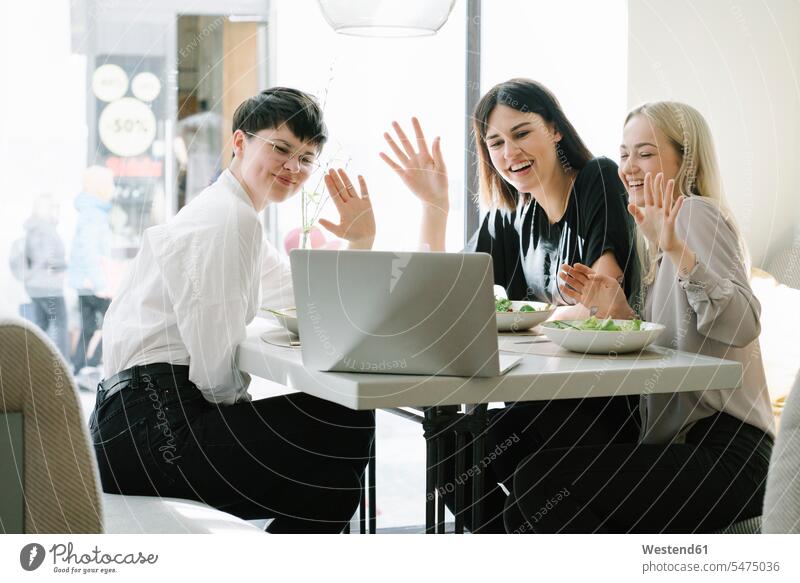 Friends having a video conference in a restaurant caucasian caucasian ethnicity caucasian appearance European healthy lifestyle healthy living Health Lifestyle