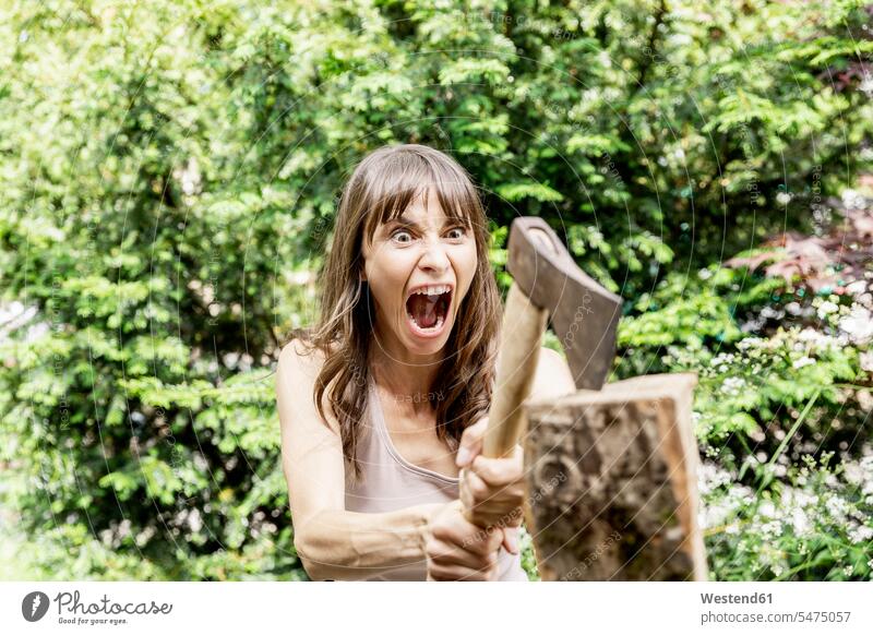 Screaming woman chopping wood human human being human beings humans person persons caucasian appearance caucasian ethnicity european decided decidedness
