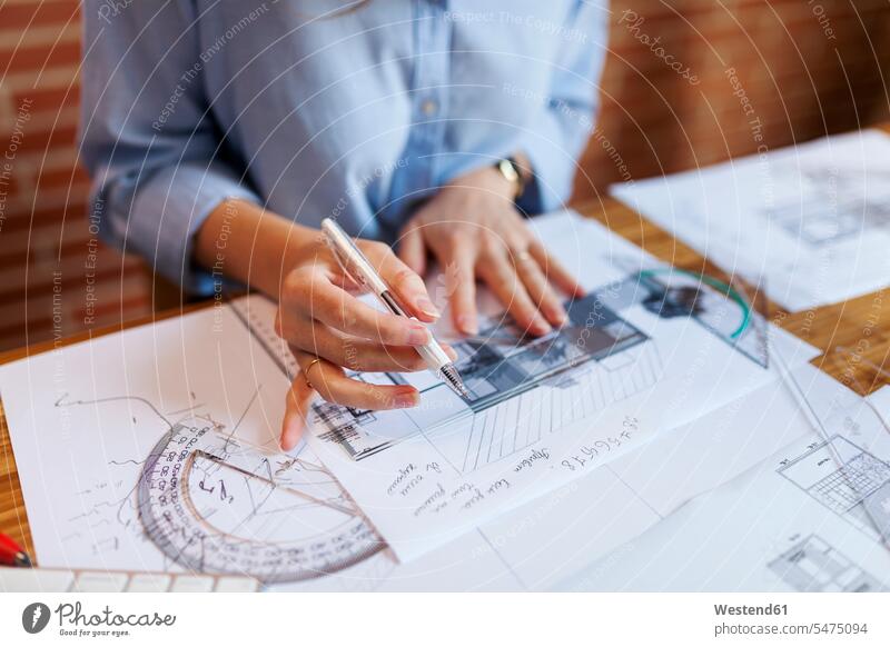 Young woman working in architecture office, drawing blueprints female architect architects female architects sketching Blueprint Blueprints Building Plan