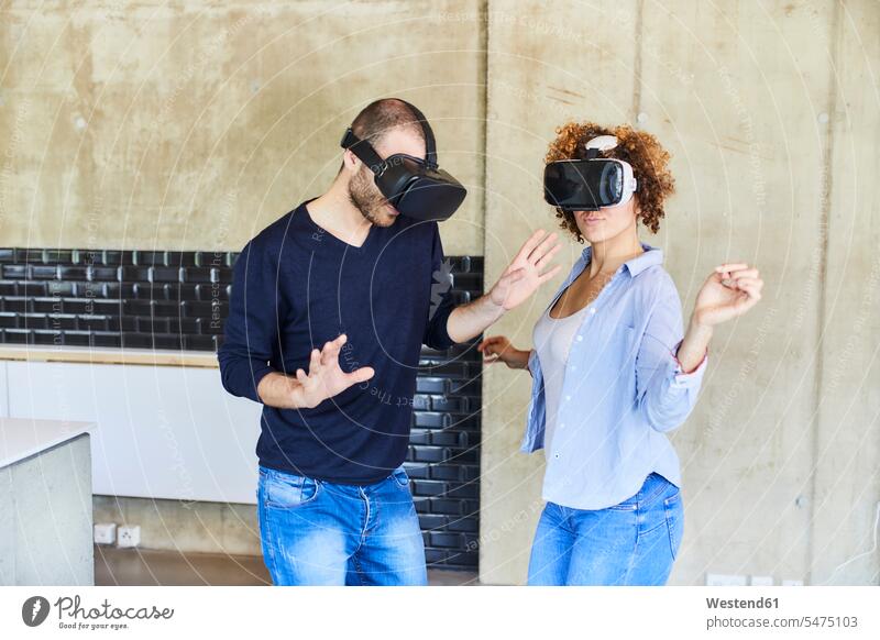 Man and woman wearing VR glasses moving virtual reality technology technologies Technological curly curly hair curls curled Connection connected Connections