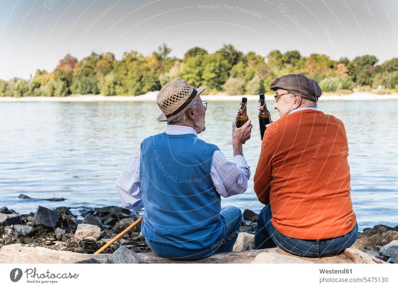 Old friends sitting by the riverside, drinking beer rear view back view view from the back Beer Bottle Beer Bottles quality of life Taking a Break resting break