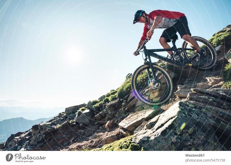 Mountainbiker mountain biking against the sun in Grisons, Switzerland bikes bicycles bike - bicycle Cycle Cycle - Vehicle exercise practising train training