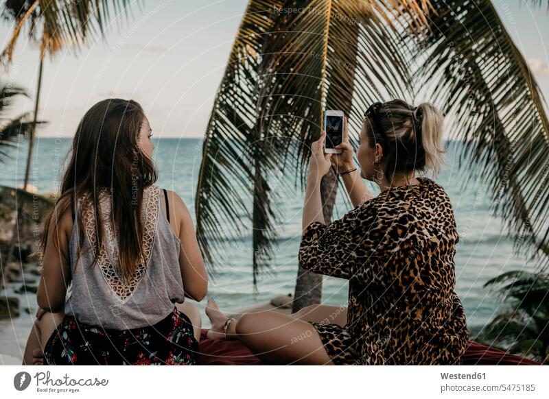 Mexico, Quintana Roo, Tulum, two young women with cell phone relaxing on the beach sea ocean female tourist Smartphone iPhone Smartphones Mattress Mattresses