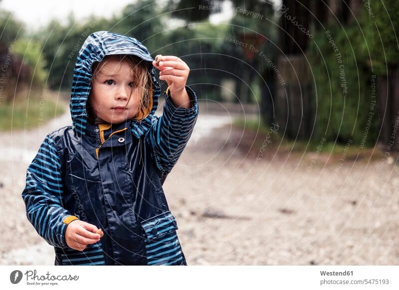 Portrait of little girl with snails in her hands standing in the rain animals creature creatures gastropod mollusca molluscs mollusk mollusks hoods colour