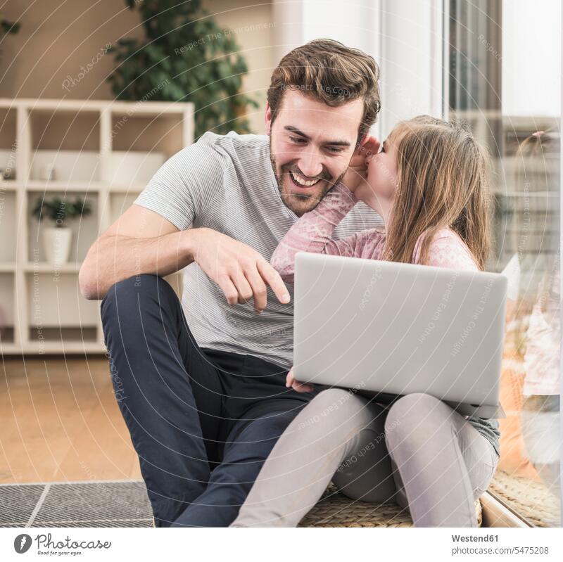 Young man and little girl surfing the net together Germany using laptop using a laptop Using Laptops one parent Wifi Wi-Fi wireless internet WLan wireless lan