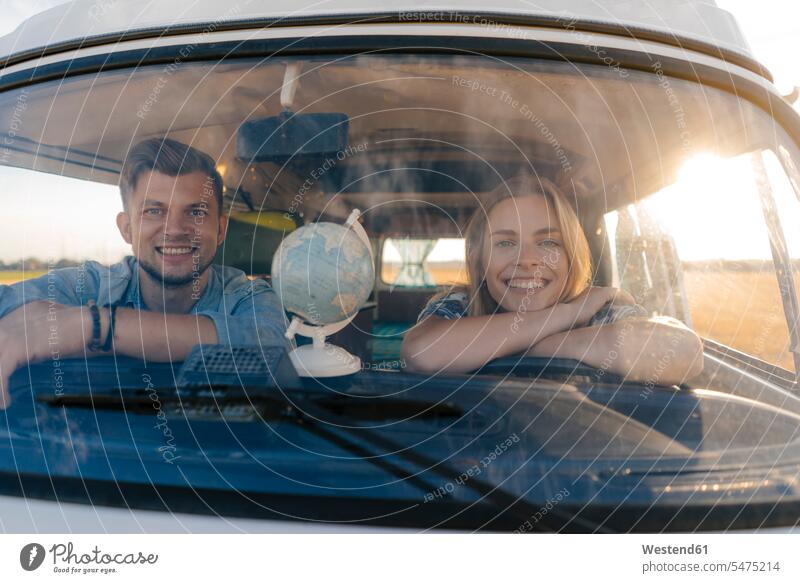 Portrait of happy young couple on a trip in camper van twosomes partnership couples excursion Getaway Trip Tours Trips happiness portrait portraits Camper