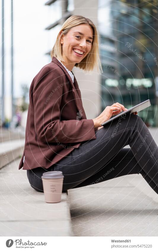 Portrait of happy young businesswoman using tablet in the city human human being human beings humans person persons caucasian appearance caucasian ethnicity