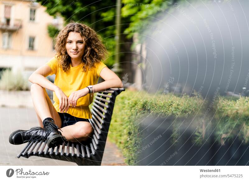 Portrait of confident young woman sitting on a bench human human being human beings humans person persons caucasian appearance caucasian ethnicity european 1