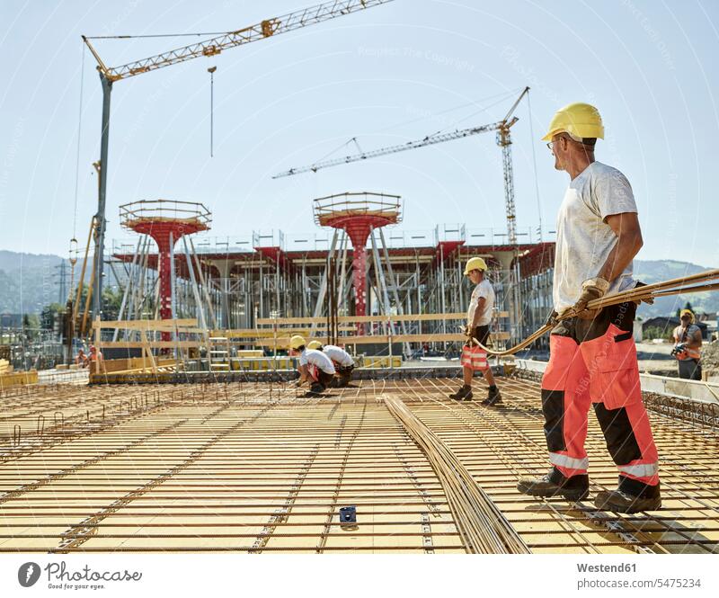 Workers on construction site preparing iron rods Building Site sites Building Sites construction sites construction worker builders working At Work constructing