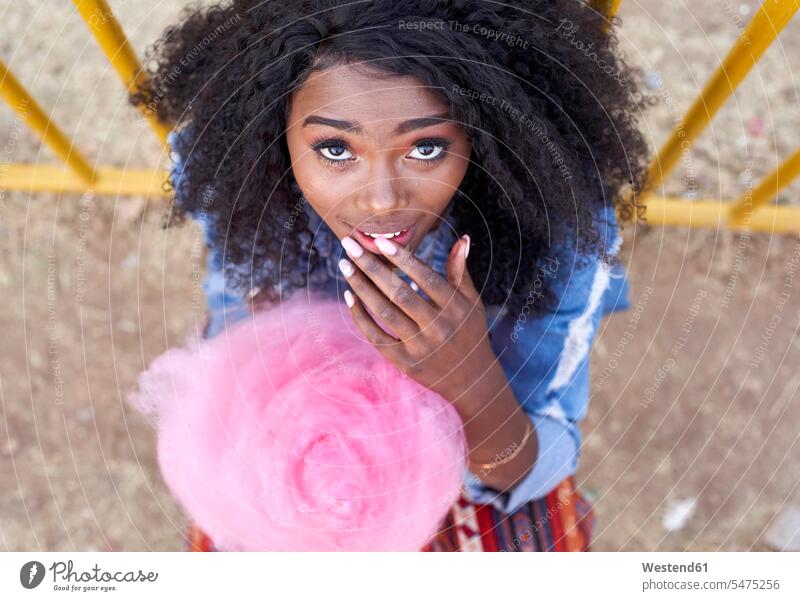 Portrait of young woman with pink candyfloss human human being human beings humans person persons African black black ethnicity coloured 1 one person only