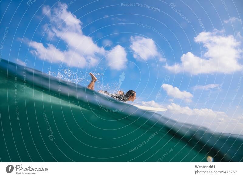 Woman surfing in the sea, Bali, Indonesia sports aquatics Water Sport watersports surf ride surf riding Surfboarding surf board surf boards surfboards