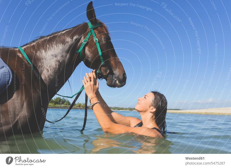 Indonesia, Bali, Woman with horse bathing bathe Taking A Bath animal-loving fond of animals love of animals water equus caballus horses rider riders