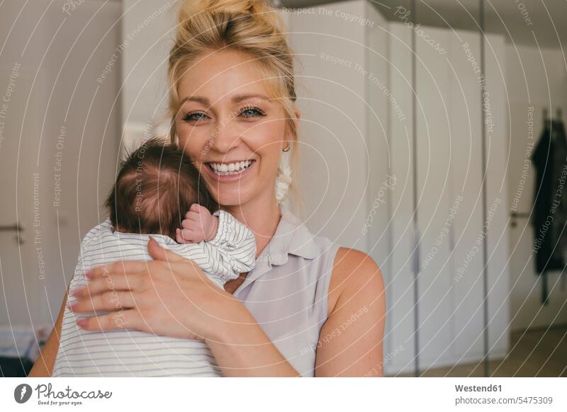 Portrait of happy mother holding her baby close to her shoulder portrait portraits mommy mothers ma mummy mama happiness infants nurselings babies shoulders