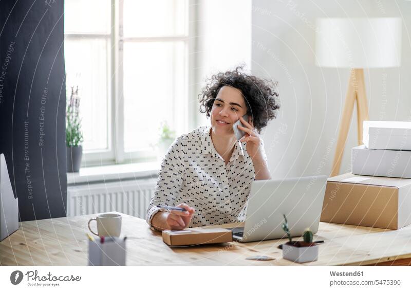 Smiling young woman on the phone in home office Occupation Work job jobs profession professional occupation business life business world business person