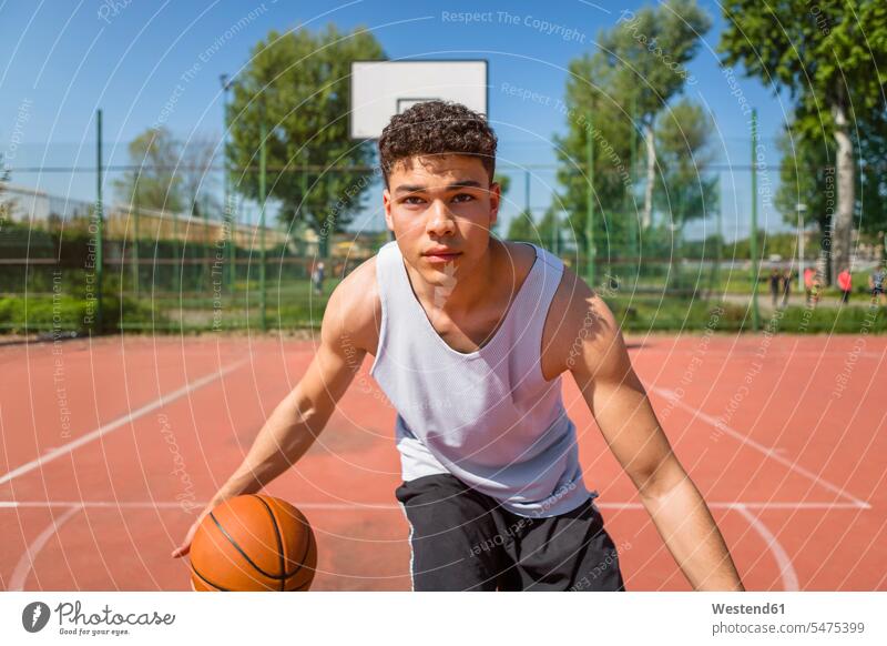 Young man playing basketball basketball game basketballs sports field sports fields motion Movement moving Vitality Verve vigour vigorous Ambition ambitious