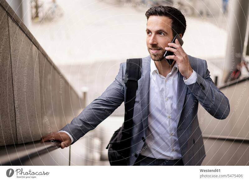 Businessman on cell phone in the city business life business world business person businesspeople Business man Business men Businessmen full suit Fullsuit suits