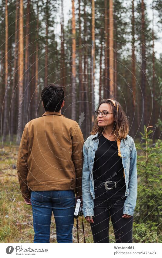 Finland, Lapland, man with camera and woman standing in rural landscape landscapes scenery terrain couple twosomes partnership couples cameras people persons