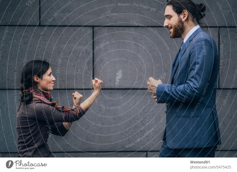 Businessman and woman fighting Business man Businessmen Business men females women business people businesspeople business world business life Adults grown-ups