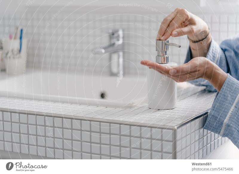Close-up of woman wputting soap on her hands in bathroom Domestic Bathroom bath room females women rooms domestic room domestic rooms Adults grown-ups grownups