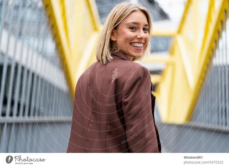 Portrait of happy young businesswoman on a bridge in the city human human being human beings humans person persons caucasian appearance caucasian ethnicity