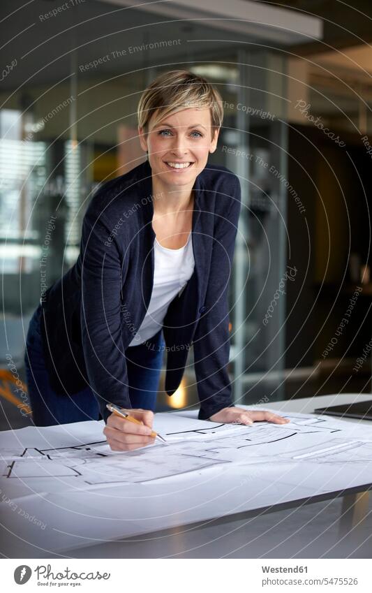 Portrait of smiling woman working on construction plan in office Occupation Work job jobs profession professional occupation business life business world