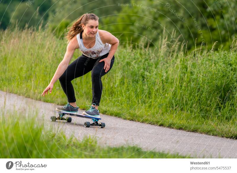 Young woman riding longboard human human being human beings humans person persons caucasian appearance caucasian ethnicity european 1 one person only