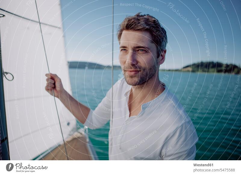 Portrait of a man on a sailing boat sailboat Sail Boat Sailboats sailing boats portrait portraits men males vessel water vehicle Adults grown-ups grownups adult