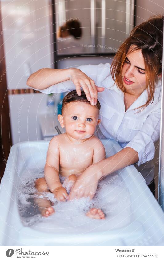 Mother bathing her little son human human being human beings humans person persons caucasian appearance caucasian ethnicity european 2 2 people 2 persons two