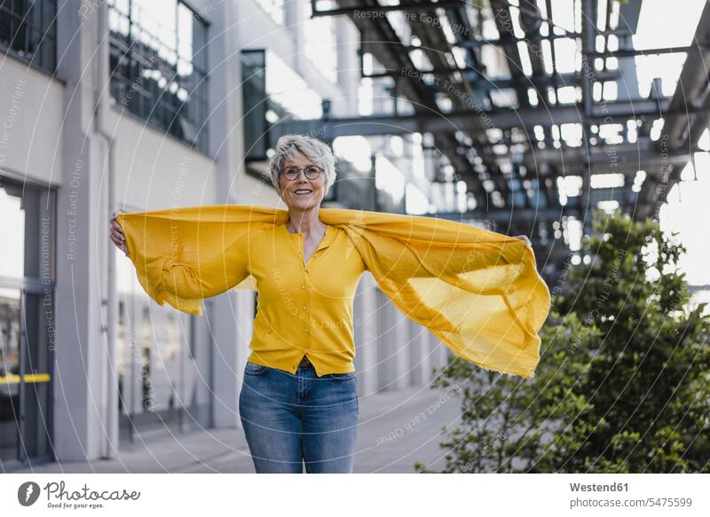 Portrait of smiling mature woman wearing yellow cardigan and scarf human human being human beings humans person persons celibate celibates singles