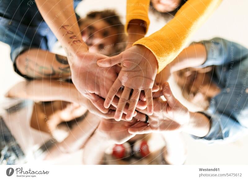 Group of happy friends huddling and stacking hands human hand human hands piling pile happiness people persons human being humans human beings friendship Spain