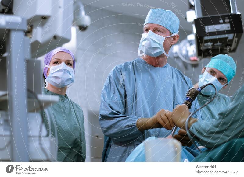 Team of neurosurgeons in scrubs during an operation hospital Medical Clinic surgical gown Operating Gown surgery surgeries operating team doctor physicians