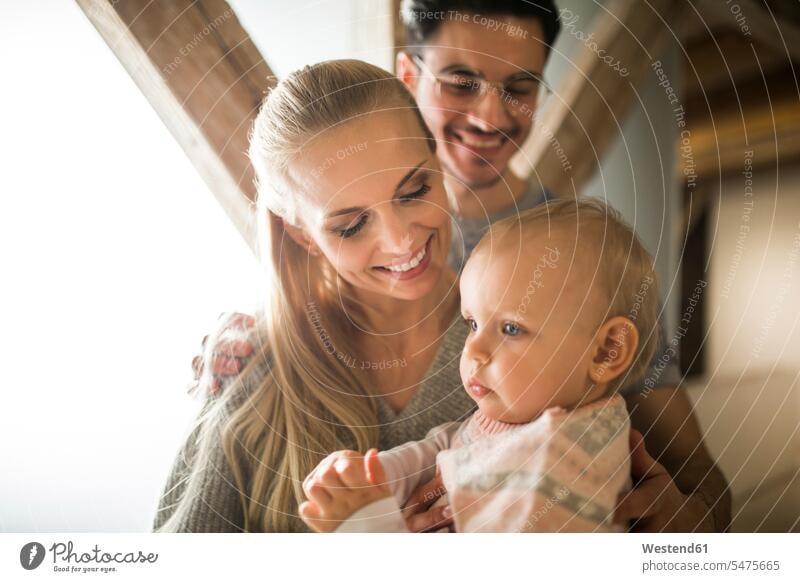 Happy young parents spending time at home with their baby girl family families infants nurselings babies happiness happy people persons human being humans