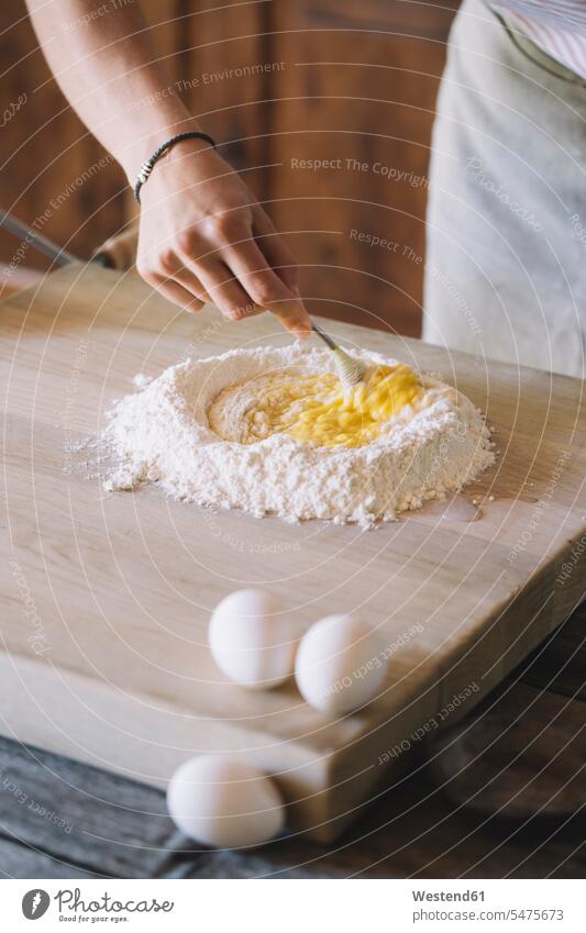 Woman preparing pasta dough, flour and eggs Food Preparation preparing food woman females women breaking Fork Forks baking bake Tradition traditional Traditions