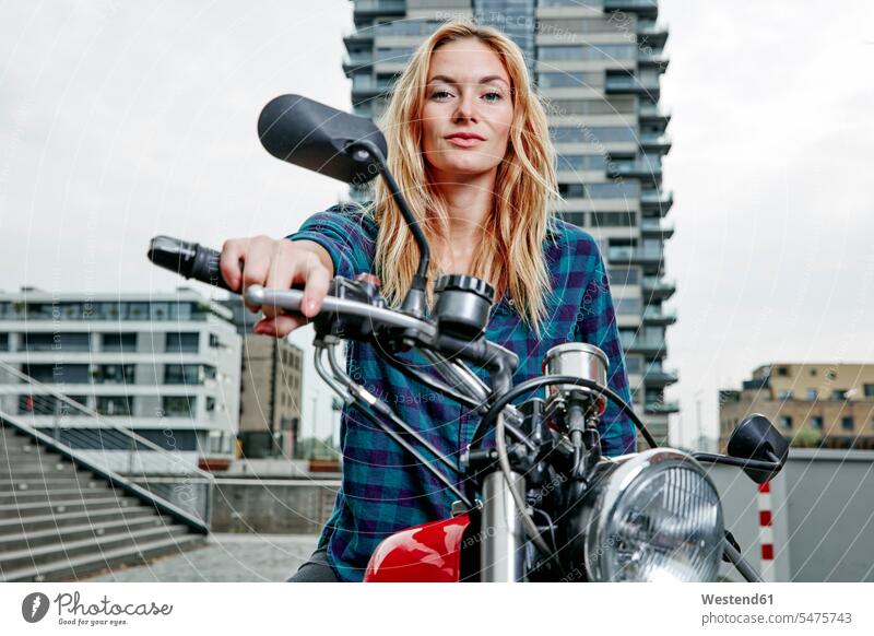 Portrait of confident young woman on motorcycle portrait portraits motorbike Motor Cycle confidence females women motor vehicle road vehicle road vehicles