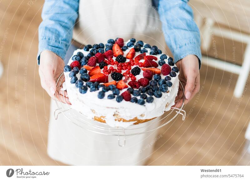 Young woman shwoing a cream cake with fresh fruits pies cakes Showing show Fruit Fruits preparing Food Preparation preparing food females women cream cakes