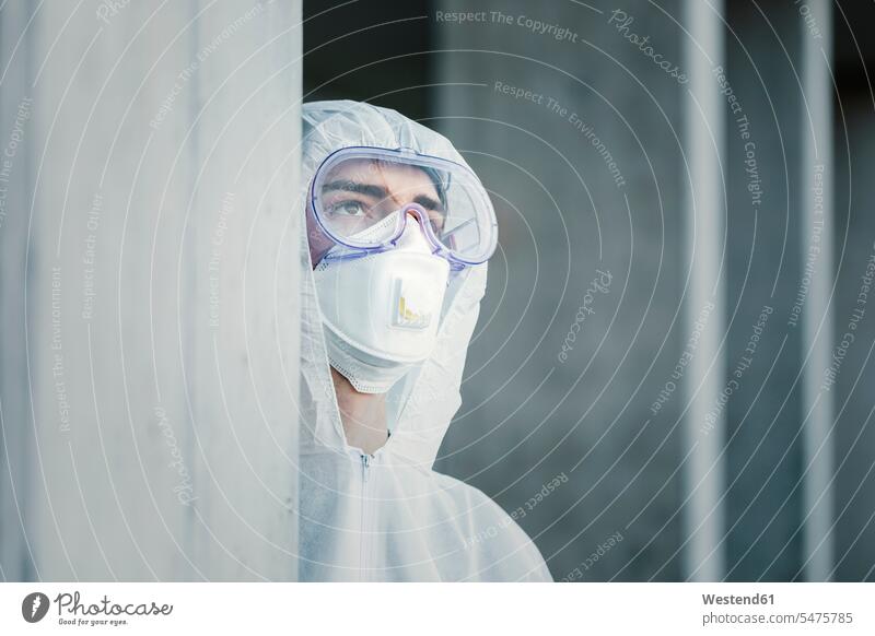Portrait of man wearing protective clothing contemplative pensively Reflective thoughtful healthy protecting safe Safety secure dangerous walls portraits