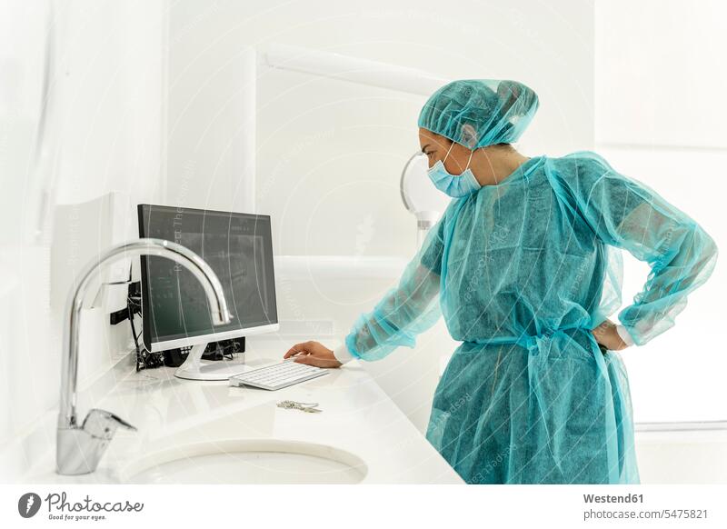 Female nurse working on computer at dentist clinic color image colour image indoors indoor shot indoor shots interior interior view Interiors Spain