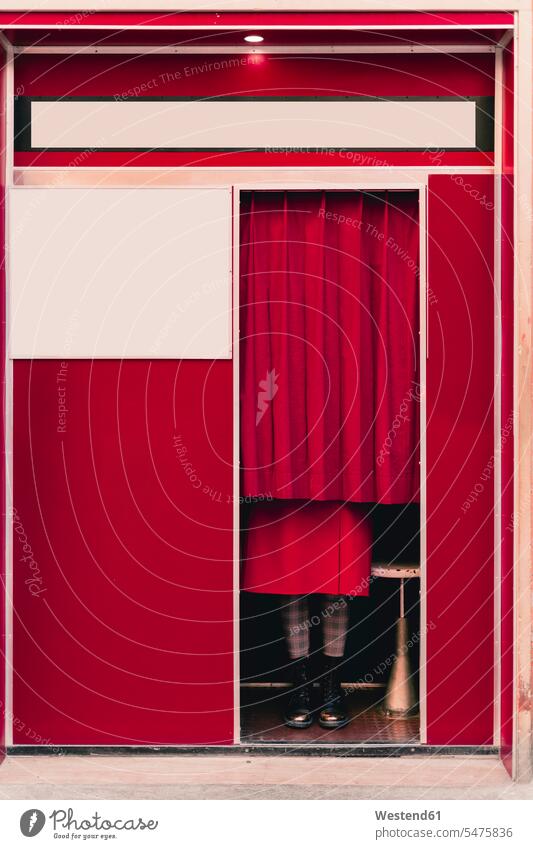 Woman wearing red coat and boots standing behind curtain in a photo booth Curtains Draperies Drapery shoes hide colour colours secrecy Secrets Ideas walls