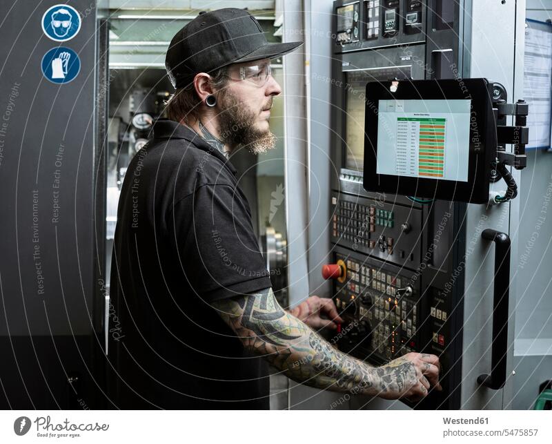 Man with tattoos working on a machine technician technicians safety glasses Protective Eyeglasses safety goggles Protective Glasses Protective Eyewear