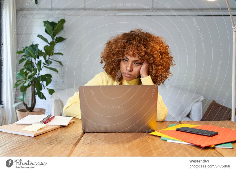 Bored businesswoman with hand in hair working on laptop at home color image colour image indoors indoor shot indoor shots interior interior view Interiors Spain
