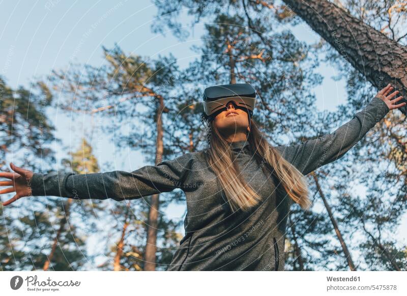 Young woman using VR goggles in nature human human being human beings humans person persons caucasian appearance caucasian ethnicity european 1 one person only