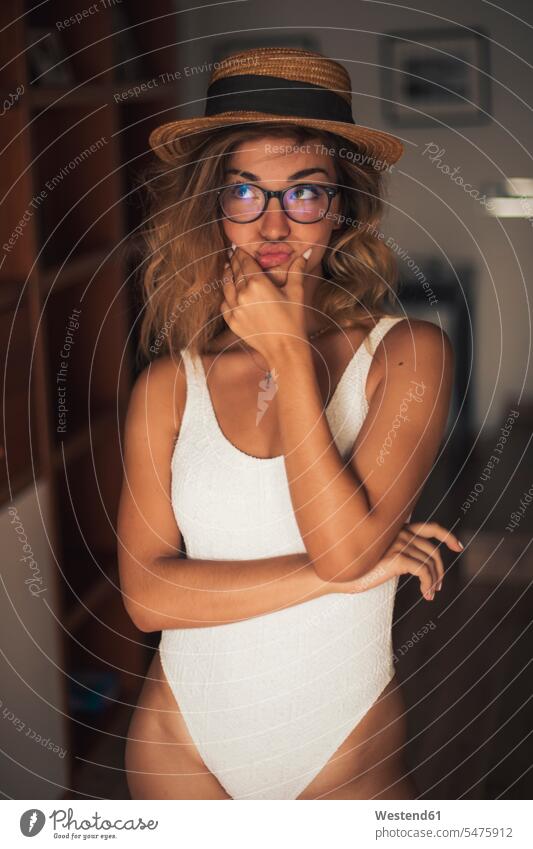 Portrait of young woman wearing a swimsuit and glasses, indoor portrait portraits waiting aspiration yearning Crave Craving aspirations wistful longing females