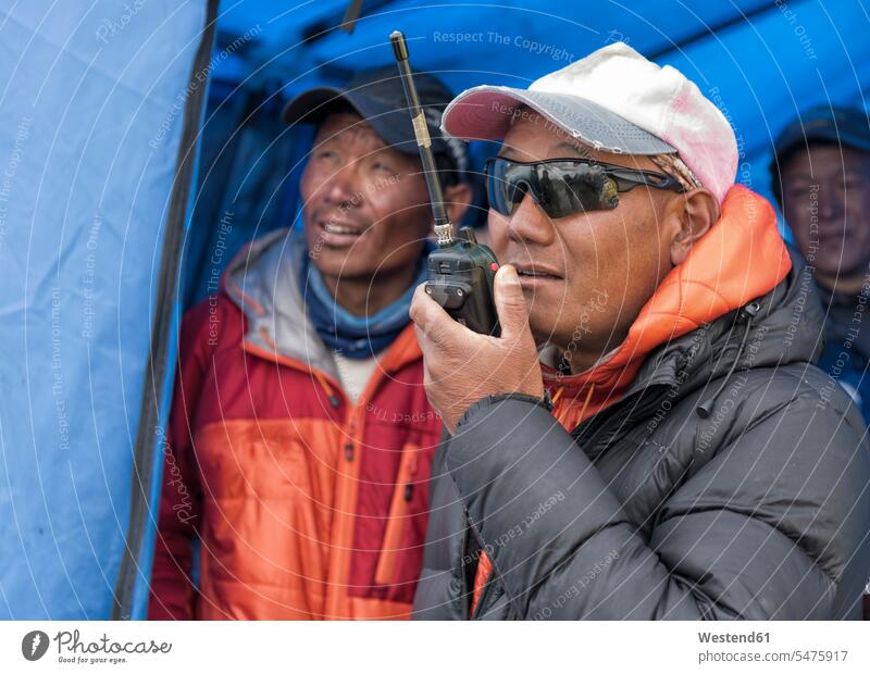 Nepal, Solo Khumbu, Everest, Sagamartha National Park, Man talking on a walkie talkie Everest region Mount Everest region radio radio device Walkie-Talkie