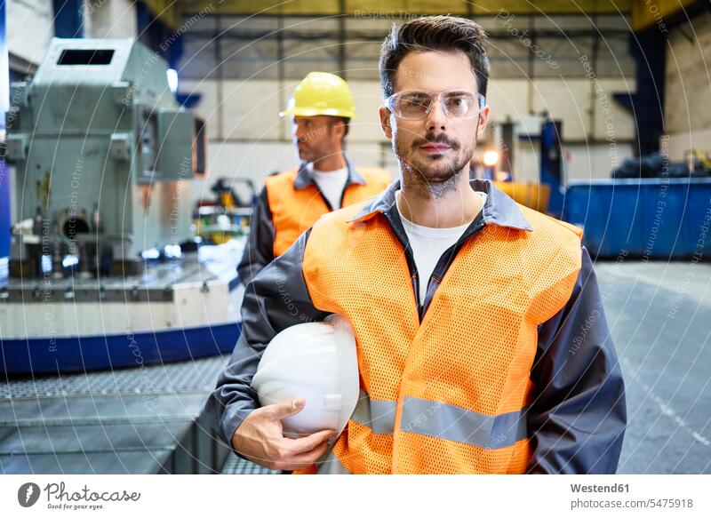 Portrait of serious man wearing protective workwear in factory earnest Seriousness austere Protective Workwear Protective Work Wear portrait portraits men males