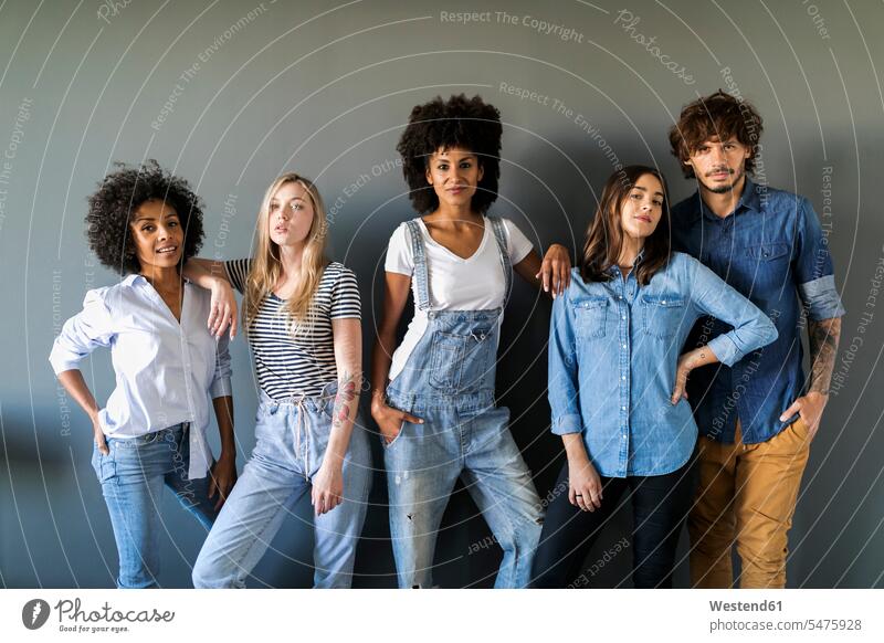 Group portrait of friends standing at a wall posing walls portraits pose Posed friendship togetherness leaning rested on confidence confident Multiracial Group