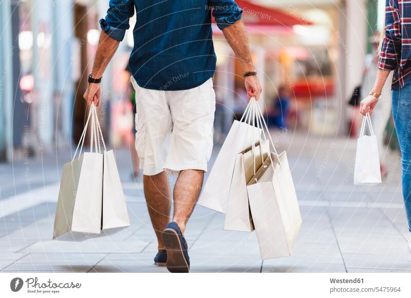 Crop view of man carrying shopping bags human human being human beings humans person persons caucasian appearance caucasian ethnicity european 2 2 people