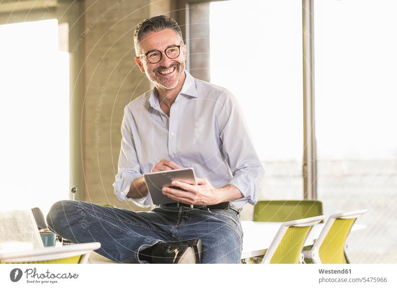 Happy mature businessman with tablet in office human human being human beings humans person persons caucasian appearance caucasian ethnicity european 1